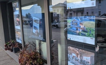 Property listings in an estate agent’s window in Saint-Gervais-les-Bains