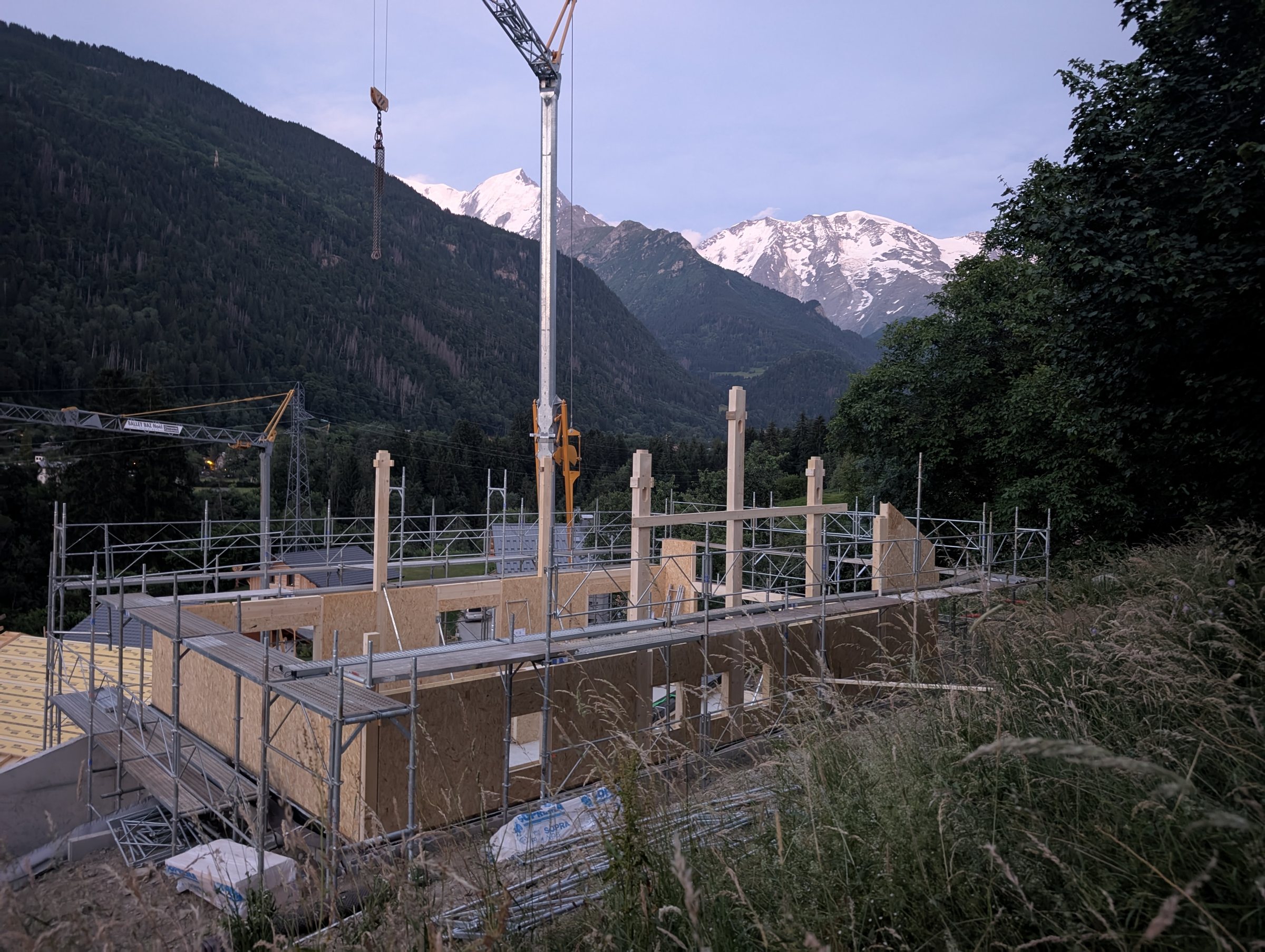 Construction of the chalet: first floor SIPs and beams with the Dômes de Miage in the distance